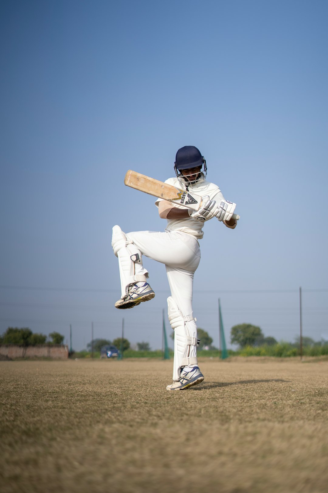 Junior Cricket Bat Size Guide: How to Choose the Right Bat for Your Child Young cricket player with a bat on a cricket field